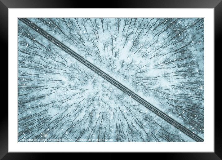 Road through winter forest Framed Mounted Print by Łukasz Szczepański