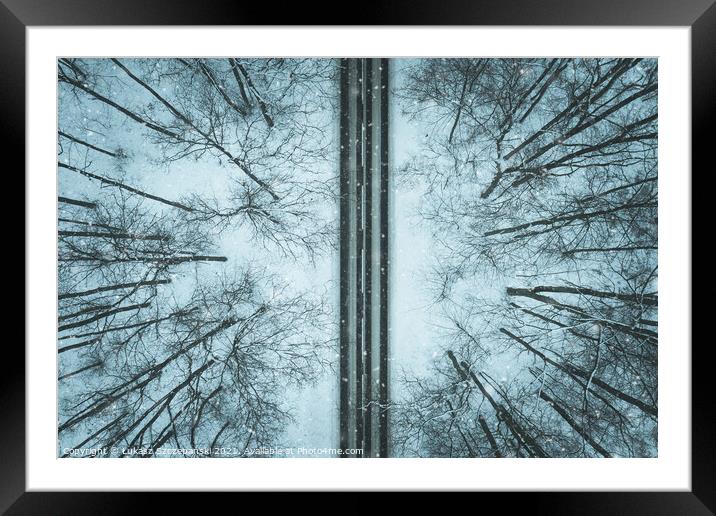 Road through winter forest Framed Mounted Print by Łukasz Szczepański