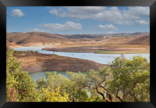 Serene river flowing through picturesque Algarve c Framed Print by Kevin Snelling