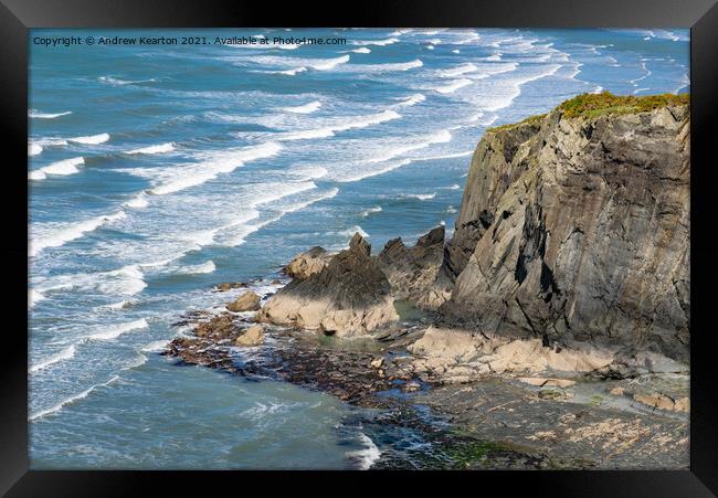 Waves and rocky cliffs at Newport, Pembrokeshire Framed Print by Andrew Kearton