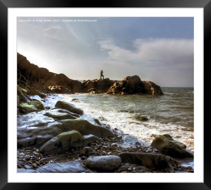 Man on the rocky shores of Tresaith, South Wales Framed Mounted Print by Philip Brown