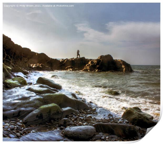 Man on the rocky shores of Tresaith, South Wales Print by Philip Brown