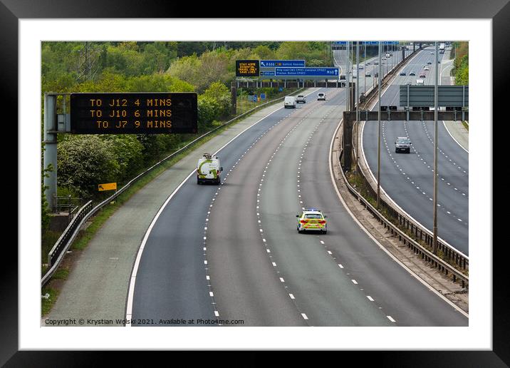 A police car responding to an emergency on the M60 motorway in UK Framed Mounted Print by Krystian Wolski