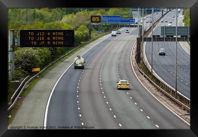 A police car responding to an emergency on the M60 motorway in UK Framed Print by Krystian Wolski