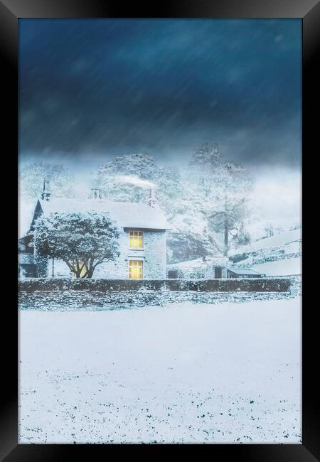 Cumbrian Cottage in snow storm Framed Print by Maggie McCall
