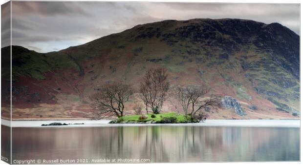 Island reflections in Crummock water  Canvas Print by Russell Burton