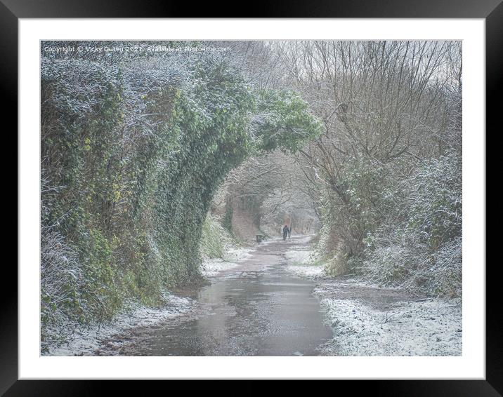 A snowy day along a path with trees  Framed Mounted Print by Vicky Outen