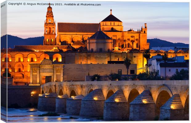 Cordoba Cathedral Mosque and Roman Bridge at dusk Canvas Print by Angus McComiskey