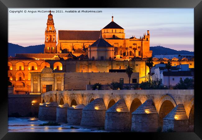 Cordoba Cathedral Mosque and Roman Bridge at dusk Framed Print by Angus McComiskey