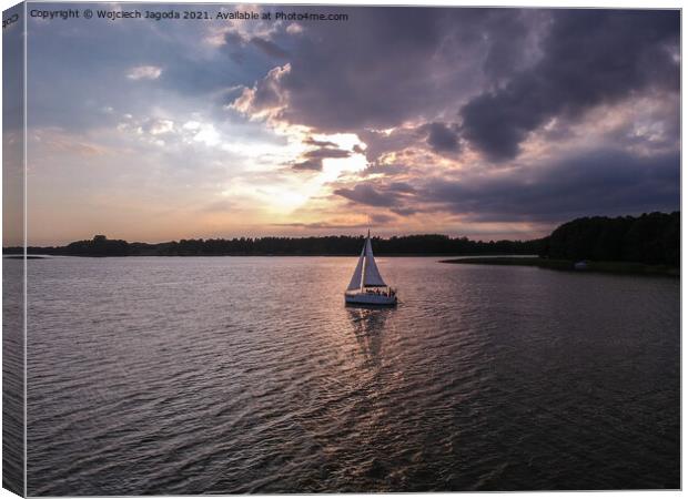 Sailing boat with a beautiful sunset Canvas Print by Wojciech Jagoda