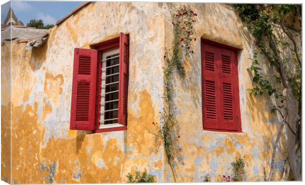 Red shutters on window in ancient district of Anafiotika in Athe Canvas Print by Steve Heap