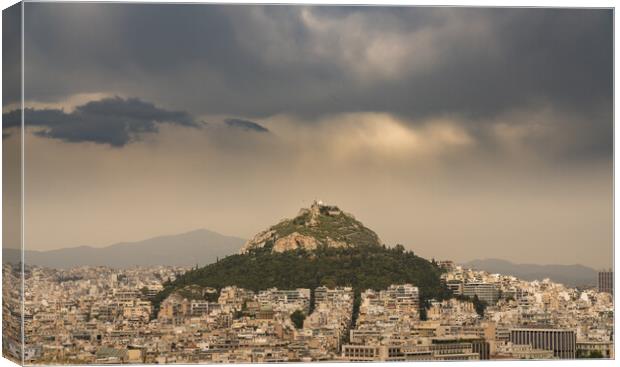 Lycabettus hill rises above Athens on stormy day Canvas Print by Steve Heap