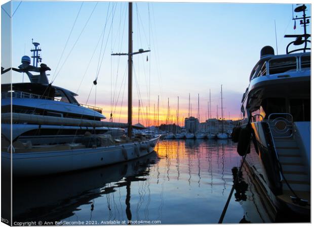  Sunset behind the boats in Cannes Canvas Print by Ann Biddlecombe