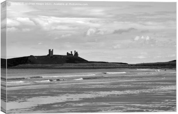 Dunstanburgh castle with waves viewed from beach. Canvas Print by Andrew Heaps