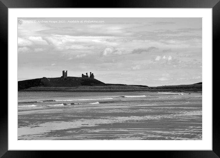 Dunstanburgh castle with waves viewed from beach. Framed Mounted Print by Andrew Heaps