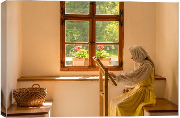 Woman working on embroidery in window alcove Canvas Print by Steve Heap