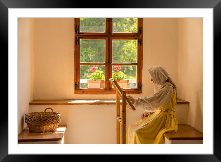 Woman working on embroidery in window alcove Framed Mounted Print by Steve Heap