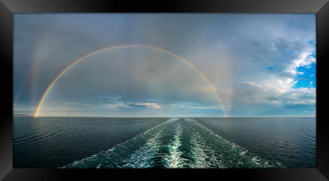 Dramatic double rainbow forms over the wake of a cruise ship at  Framed Print by Steve Heap