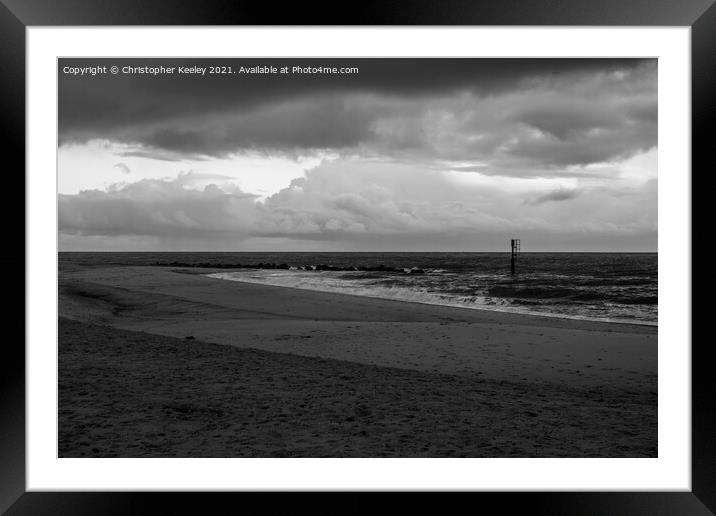 Moody, cloudy skies over Caister beach  Framed Mounted Print by Christopher Keeley