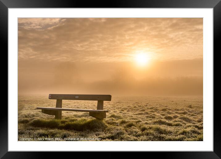 A bench at sunrise on a foggy winter morning Framed Mounted Print by Gary Holpin