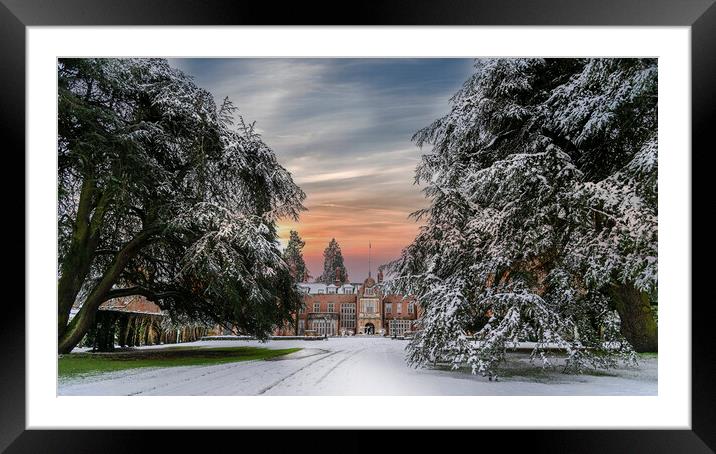 Sunset over a snow covered Tylney Hall Hotel Framed Mounted Print by Dave Williams