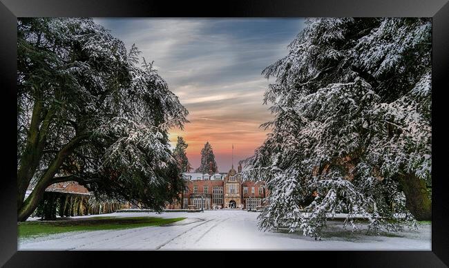 Sunset over a snow covered Tylney Hall Hotel Framed Print by Dave Williams