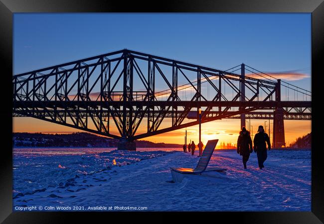 People walking by the frozen St Lawrence river in Quebec Canada Framed Print by Colin Woods