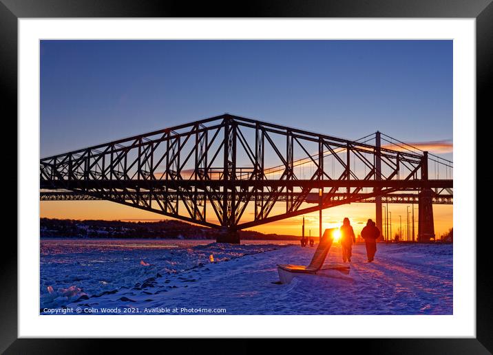 People going for an evening walk at sunset by the frozen St Lawrence River, Quebec, Canada Framed Mounted Print by Colin Woods