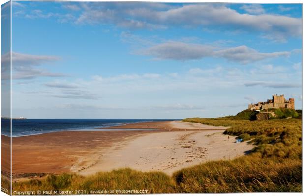 Bamburgh Castle by the Deserted Beach Canvas Print by Paul M Baxter