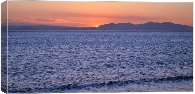 Arran and its mountains silhouetted by a setting s Canvas Print by Allan Durward Photography