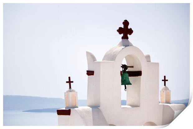 A tower top of a church with cross sign and bells architecture located in oia village in one of Cycladic island in Santorini, Greece against sea. Print by Arpan Bhatia