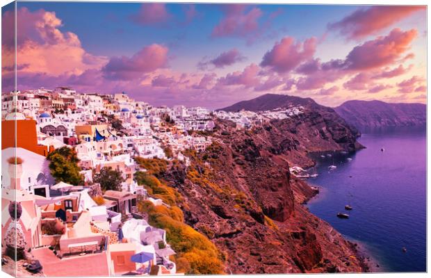 Santorini, Greece: Beautiful city of Oia ( Ia ) on a hill of white houses with blue roof against dramatic pink sky, located in Greek Cyclades islands in Mediterranean sea Canvas Print by Arpan Bhatia