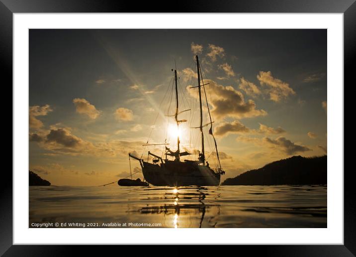 Yacht in sunset taken from the water in Philippines. Framed Mounted Print by Ed Whiting