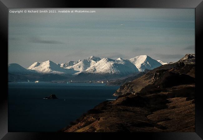 Snow covered Red Cuillin Hills beyond the Sound of Raasay. Framed Print by Richard Smith