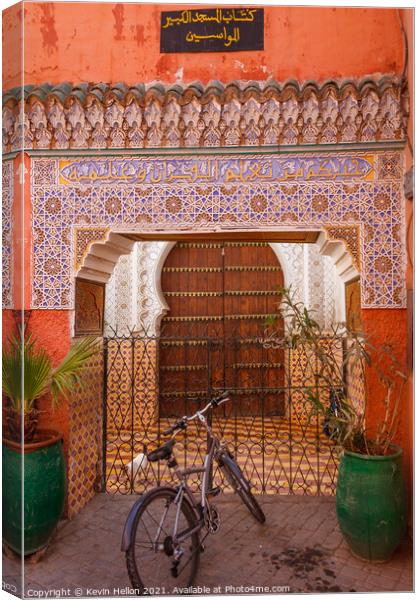 Moroccan doorway and bicycle Canvas Print by Kevin Hellon