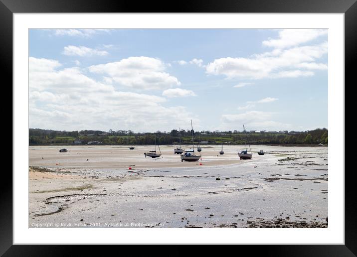 Boats moored in Red Wharf Bay Anglesey at low tide Framed Mounted Print by Kevin Hellon