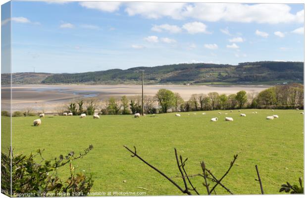 View across fields to Red Wharf Bay in Anglesey, W Canvas Print by Kevin Hellon