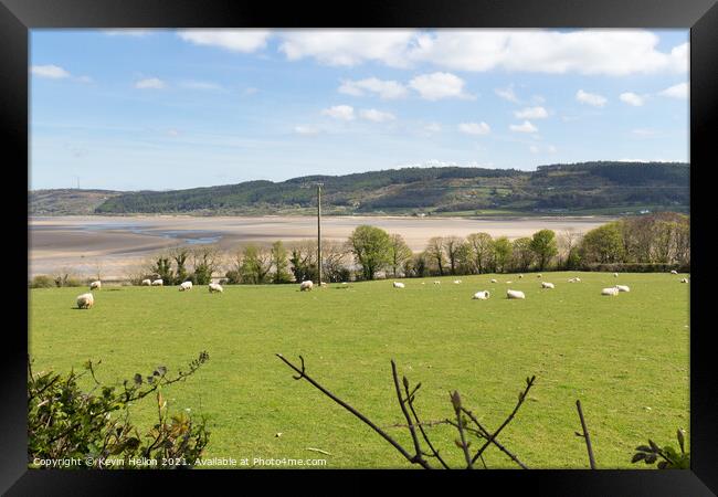 View across fields to Red Wharf Bay in Anglesey, W Framed Print by Kevin Hellon