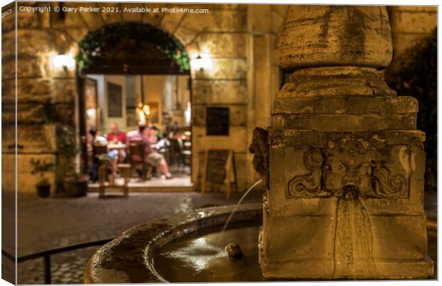Roman fountain, with a small Trattoria in the background, at night Canvas Print by Gary Parker