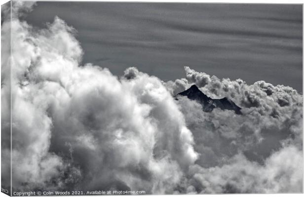 An alpine peak emerges from the clouds Canvas Print by Colin Woods