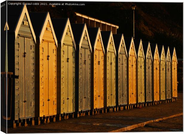 Sunlit besch huts. Canvas Print by paul cobb