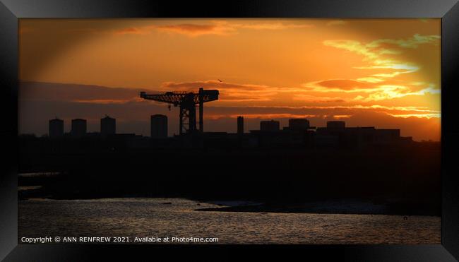 Finneston Crane lit by rising sun Framed Print by ANN RENFREW