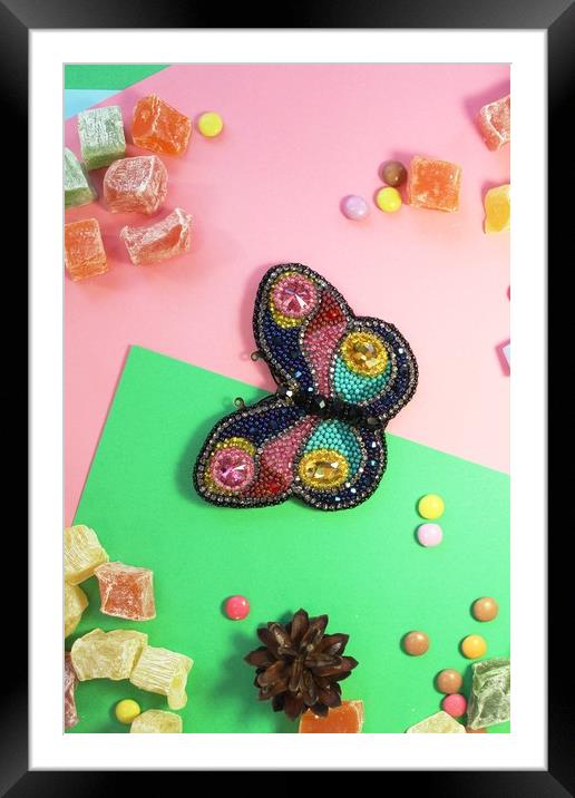 butterfly on colored paper with multicolored sweets Framed Mounted Print by Andrei Babchanok