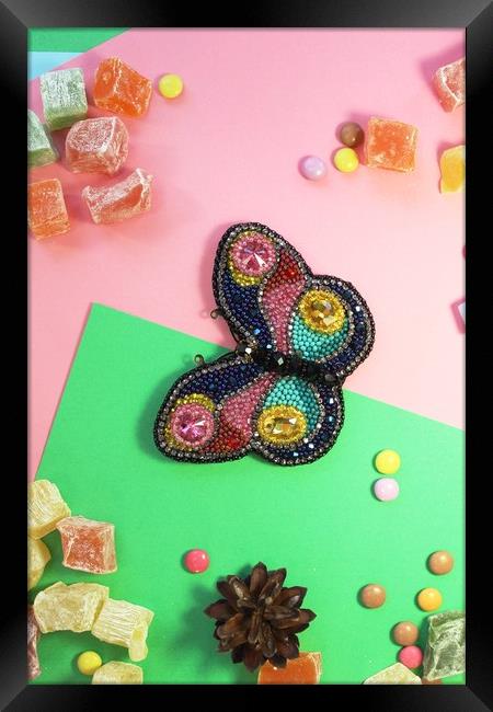 butterfly on colored paper with multicolored sweets Framed Print by Andrei Babchanok