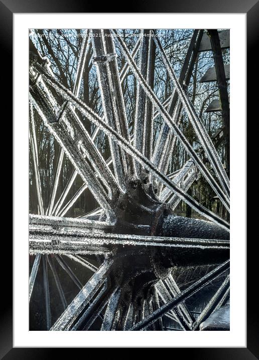 frozen ice on water wheel Framed Mounted Print by Kevin White