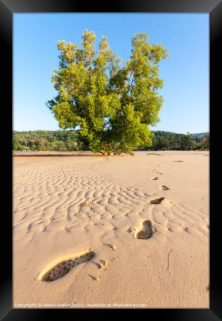 Footprints in the sand Framed Print by Kevin Hellon