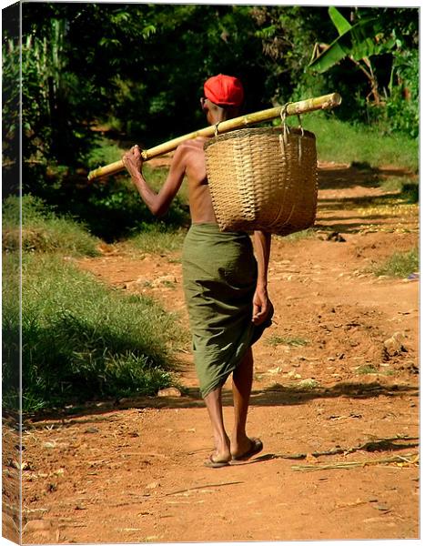 Man in Lungi Walking with Basket, Myanmar (Burma) Canvas Print by Serena Bowles
