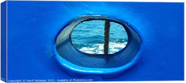 Bull´s eye in a blue iron wall from a ship. 1b Canvas Print by Hanif Setiawan