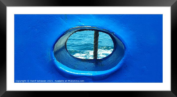 Bull´s eye in a blue iron wall from a ship. 1b Framed Mounted Print by Hanif Setiawan