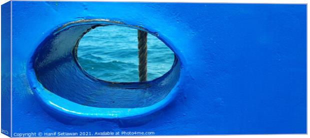 Bull´s eye in a blue iron wall from a ship. 2b Canvas Print by Hanif Setiawan